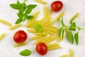 Small ripe tomatoes, fresh basil ,pasta top view Royalty Free Stock Photo