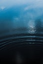 Small ripples on calm water with deep blue reflections Royalty Free Stock Photo