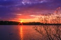 Nice colorful sunset over the water. Romantic landscape in front of a lake.