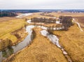 Small river with dry trees without leaves in winter / early spring aerial view. Moody overcast weather Royalty Free Stock Photo