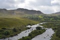 Small River Flow in Green Vegetation and Mountain Landscape in a National Road in Ireland Royalty Free Stock Photo