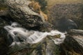 Small river flowing through some rocks and under a bridge near Transfagarasan Road in Romania Royalty Free Stock Photo