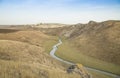 Small river and hills in prairie Royalty Free Stock Photo