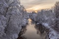 Small river running through the white snowy forest on frosty winter evening Royalty Free Stock Photo