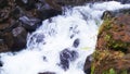 Small river under a waterfall