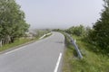 Small road bending into fjord fog near Grunnfor, Norway