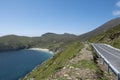 Small road on a hill leading to a sandy Keem beach in Achill island, Ireland. Warm sunny day. Clear blue sky. Irish landscape. Royalty Free Stock Photo