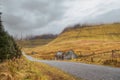 Small road into mountains Forest on the left empty fields and small abandoned house on the right. Geniff Horseshoe loop drive