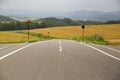 Small road with road sign and wheat field in Biei town, Hokkaido