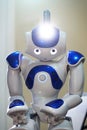 A small robot with a human face and a humanoid body. Artificial intelligence - AI. Blue-and-white robot.