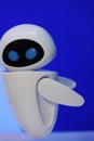 A small robot with a humanoid body on a blue background . Artificial intelligence-AI. Blue-white robot.