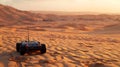 A small robot rover exploring a vast desert landscape. The setting sun casts long shadows across the sand dunes
