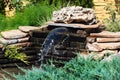 Small rockery with waterfall in a garden Royalty Free Stock Photo