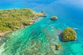 Small rocky island in the blue lagoon, view from above