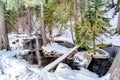 Small rocky stream on hilly terrain with fresh white snow in winter season Royalty Free Stock Photo