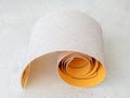 Small roll of extra coarse aluminum oxide sandpaper. Abrasive paper for dry sanding. Processing wood and metals, furniture Royalty Free Stock Photo