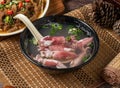 Small roll soup in a dish isolated on mat side view on dark wooden table taiwan food