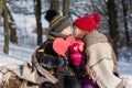 Small romantic couple with a gift and paper heart