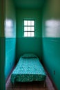 Small room with bed covered in light blue blankets and pillows. Generative AI Royalty Free Stock Photo