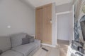 Small room in a house with a custom-made built-in wardrobe and sofas fitted into the space Royalty Free Stock Photo