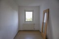Small room in need of renovation, the door leaning against the wall, concept for affordable living space out of reach in times of