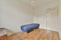 A small room with a single couch in blue