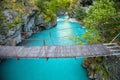 Small rope bridge over green Utla river in Utladalen, Norway Royalty Free Stock Photo