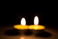 Small round candle burning in the dark tablet Royalty Free Stock Photo