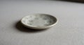 A small, round ceramic plate with Royalty Free Stock Photo