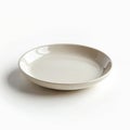 Small round ceramic plate with smooth glossy neutral surface. Minimalist tableware dish perfect for serving desserts appetizers Royalty Free Stock Photo