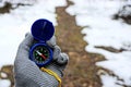 Compass in hand against the backdrop of a path in the winter forest Royalty Free Stock Photo