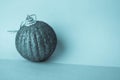 Small round glass plastic beautiful xmas festive Christmas ball, Christmas toy plastered over sparkles on a blue background Royalty Free Stock Photo