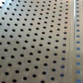 Small round holes in a thin metal sheet