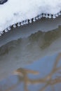 Small round icicles over water Royalty Free Stock Photo