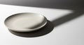A small, round, off-white ceramic plate Royalty Free Stock Photo