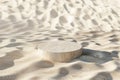 A small, round stone is sitting on a sandy beach Royalty Free Stock Photo