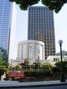 Small round white church surrounded by modern high-rise office towers in city