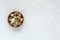 Small round wooden bowl of quial eggs, minimalism, top view