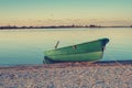 Small row boat on coastline during sunrise Royalty Free Stock Photo