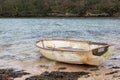 Small rowing boat moored on the beach