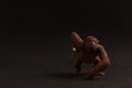 Small rubber ape toy isolated on a black background Royalty Free Stock Photo