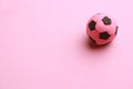 Small rubber ball isolated on a pink background