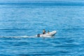 Small Rubber Dinghy in Motion with Wake in the Blue Mediterranean Sea Royalty Free Stock Photo