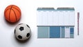 Small rubber toy basketball and soccer ball with a workout plan schedule Royalty Free Stock Photo