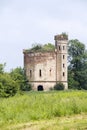 Small ruined abandoned castle overgrown in vegetation