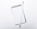 Small ruled spiral bound notebook and pencil