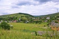 A small rural village with many houses and several churches at the foot of the gentle green mountain Royalty Free Stock Photo