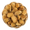 Small rusks with raisin in wicker basket isolated on white