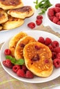 Small russian pancakes with raspberry and mint for breakfast Royalty Free Stock Photo