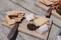 Small rustic snack board on the wooden table in natural sunlight